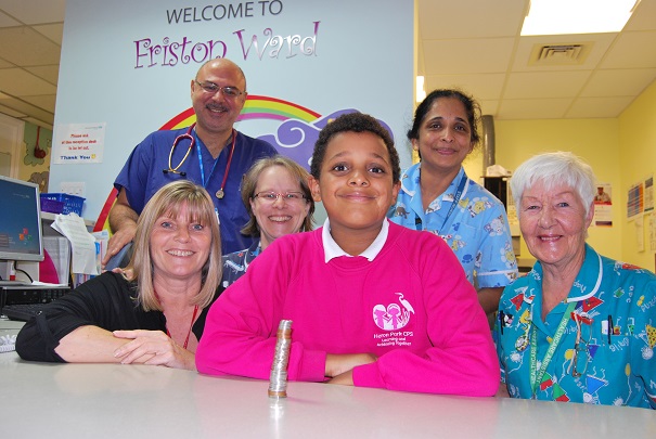 Tendai Nengoma with his donation and staff on Friston Ward