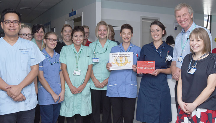 The De Cham team ward receiving their award from Dr Adrian Bull, Chief Executive