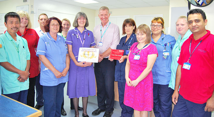 The Hailsham 2 ward team receiving their award from Dr Adrian Bull, Chief Executive