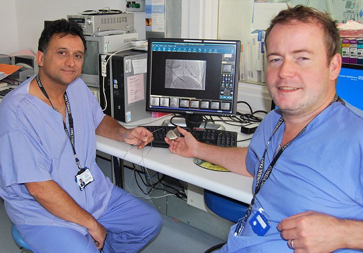 Consultant Cardiologists Professor Nikhil Patel and Dr Rick Veasey with new heart device and lead