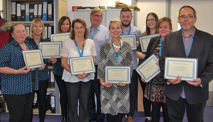 The team, receiving their award from Chairman, David Clayton-Smith