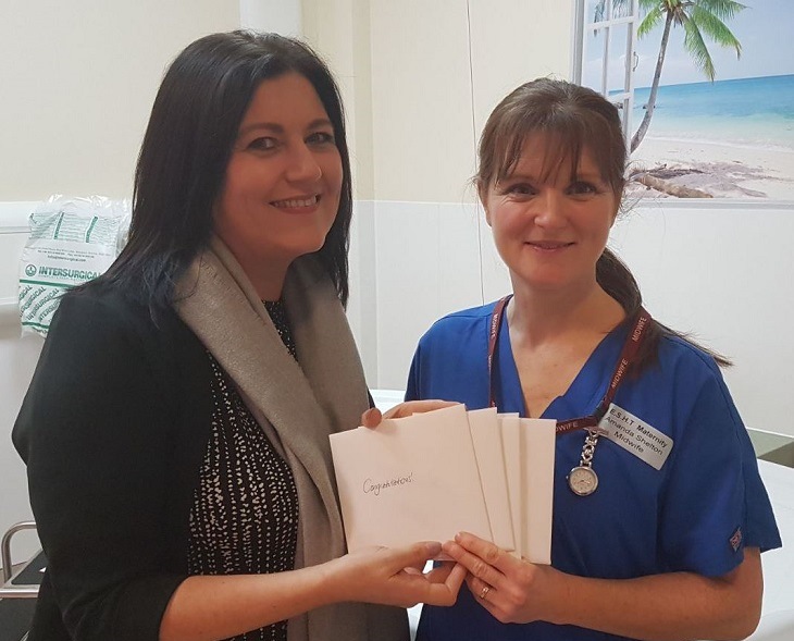 Tina Reed from The View Hotel presents gift tokens to Midwife Amanda Shelton