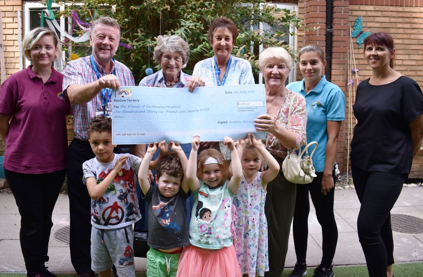 Children and staff from the Rainbow Nursery handover their donation to Friends trustees
