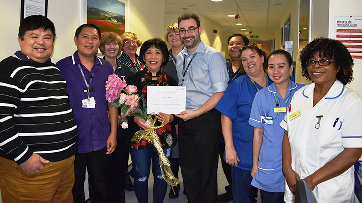 Healthcare Assistant, Teresita Taruc is presented with a certificate on her retirement by Dr Joel Newman - (Pevensey Ward Matron, Art Lazaro (2nd left))