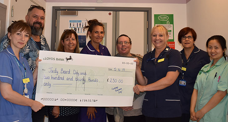 Tracy-Anne Mitchell with Ian Gillam hand over a cheque to the Judy Beard Unit team