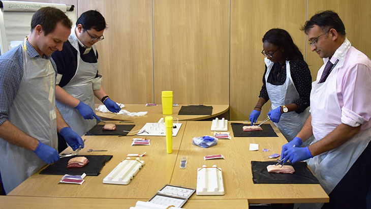 Professor Nikhil Patel demonstrates stitching technique to specialist cardiac doctors