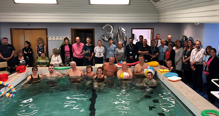 Staff and patients celebrate 30 years of Aquatic Physiotherapy at Eastbourne DGH (Anna Carter Lead Aquatic Physiotherapist centre in pool)
