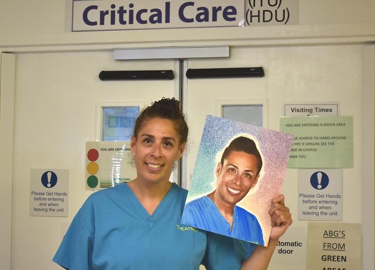 Staff Nurse Tasha Rainsley with a copy of her portrait