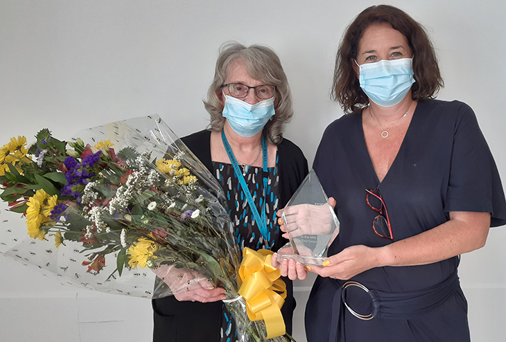 Janet Garrood, Access and Bookings Co-Ordinator presented with an engraved glass trophy by Trust Chief Executive, Joe Chadwick-Bell for 50 years NHS service