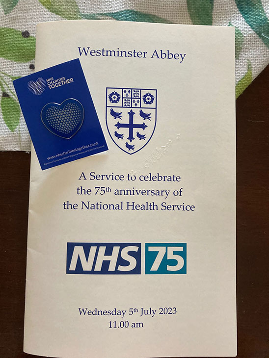 The order of service together with a heart shaped badge.
