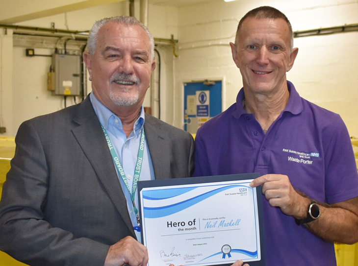 Steve Pheonix, chairman presents Neil Maskell with hero of the month certificate