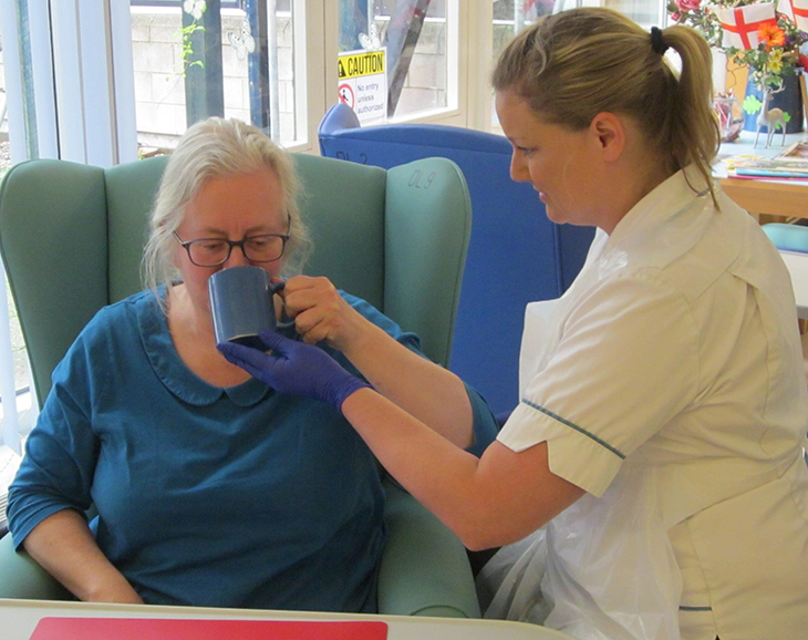 Speech and language therapist helping a patient