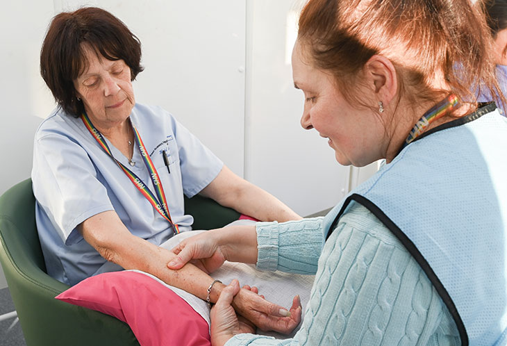 Critical care team carrying out hand massages