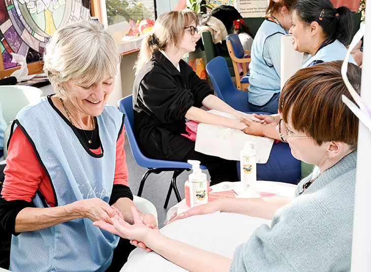 Critical care team carrying out hand massages