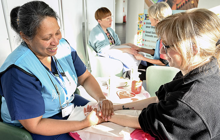 Critical care team carrying out hand massages