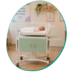 Photograph of a baby in an incubator.
